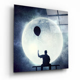 Mann auf Bank mit Ballon und Mond Glasbild - 40x40 cm
