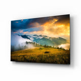 Goldener Sonnenuntergang Wiese Nebelige Berge Glasbild - 72x46 cm