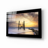 Vieux pilotis de jetée au coucher du soleil tableau en verre - 72x46 cm